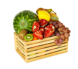 Many different fresh fruits in wooden crate isolated on white