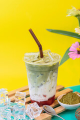 Matcha green tea, strawberries and flavored milk, blended into a drink.