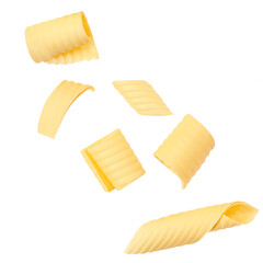 Flying Butter curls rolled up isolated on white background. Fresh butter pieces explosion