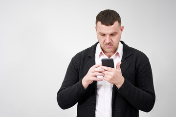 Portrait of businessman using smartphone over gray background