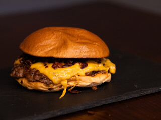Cheese burger with bacon and egg on black background	
