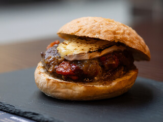 Cheese burger with bacon and egg on black background	
