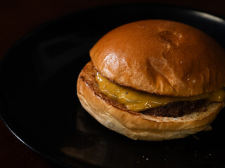 Cheese burger with bacon and egg on black background	
