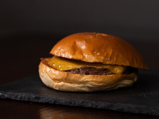 Cheese burger with bacon and egg on black background	
