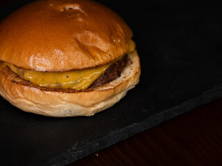 Cheese burger with bacon and egg on black background	
