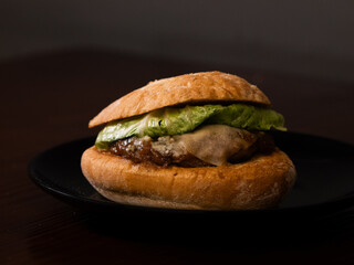 Cheese burger with bacon on black background