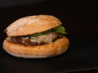Cheese burger with bacon on black background