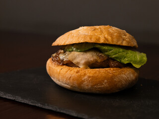 Cheese burger with bacon on black background