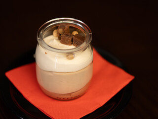 Glass of tiramisú on black background