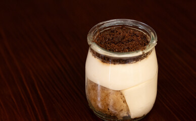 Glass of tiramisú on black background