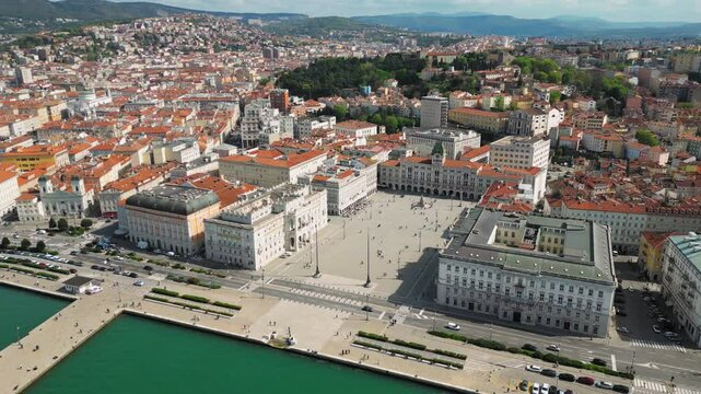 The aerial view of Piazza Unit&agrave; d'Italia in Trieste, Italy, with bustling city traffic and iconic landmarks. Trieste, Italy.