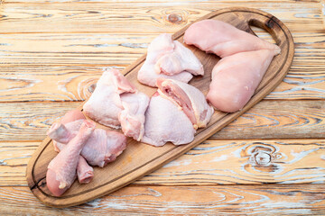 Raw mixed chicken meat parts  for cooking on rustic background