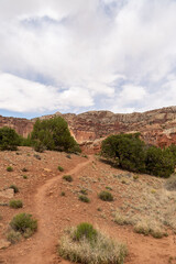 A cloudy and sunny view of red rocks at Capitol Reef National Park in Utah.
