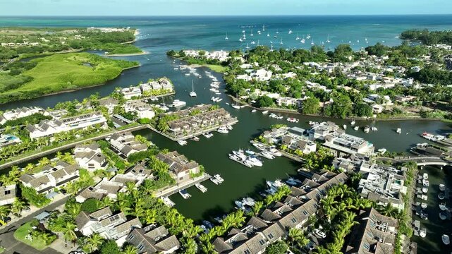 Aerial view: luxury yachts and apartments in La Balise Marina, Mauritius island