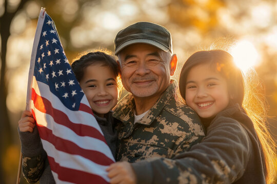 Military family is celebrating veterans day, holding the american flag at sunset - Powered by Adobe