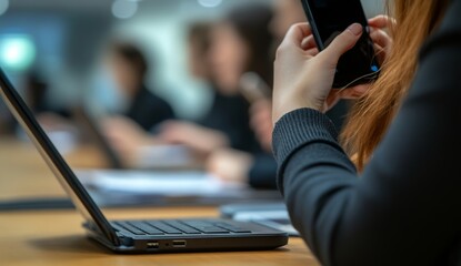 A young businessman's crew works on an innovative startup project. A generic design notebook covers a wooden table. The hands are analyzing the plans and the keyboard is on the keyboard. The