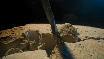 Detailed View of Drilling into Stony Ground with Visible Debris