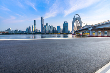 Fototapeta premium Asphalt road and bridge with modern city skyline scenery in Guangzhou. car advertising background.