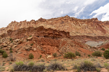 A cloudy and sunny view of red rocks at Capitol Reef National Park in Utah.