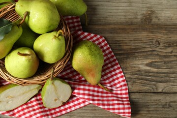 Fresh green pears on wooden table, flat lay. Space for text