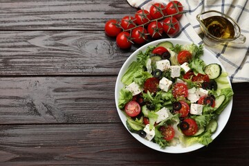 Delicious salad with feta cheese on wooden table, flat lay. Space for text