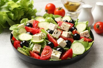 Delicious salad with feta cheese on grey table, closeup