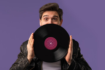 Handsome Man Dancing Vinyl Record Disc On Violet. Hobby, Music Lover, Collection