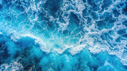 Obraz premium Top view of blue frothy sea surface , ocean, waves, water, turquoise, foam, texture, aerial, nature, marine, background, seascape