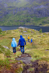 Obraz premium Cute little child, enjoying the view in small A village on the end of Lofoten, Norway