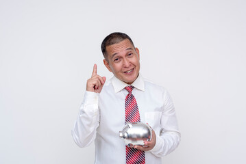 A middle-aged office professional giving reminders to save money while holding a chrome piggy bank. Isolated on a white background.
