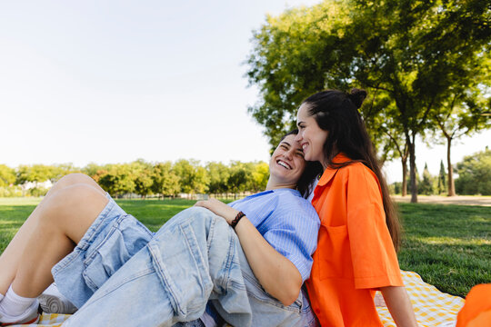 Lesbian couple enjoying a sunny day together in park