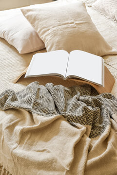 Cozy bedroom scene with open book on bed