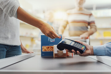 Woman paying with a credit card at the supermarket