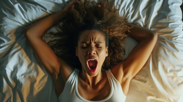 High Angle View Of A Young Woman In Bed Getting Orgasm