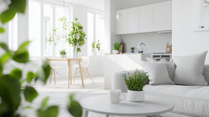 A bright, modern living room with white furnishings, green plants, and a minimalist aesthetic, offers a serene and airy atmosphere.