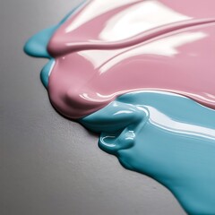 Close up view of light pink and light blue paint mixing isolated on grey