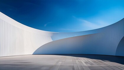 A minimalist, modern architectural scene with a curved wall on the right, forming sharp lines and geometric shapes in white against a blue sky. Smooth curves and subtle.