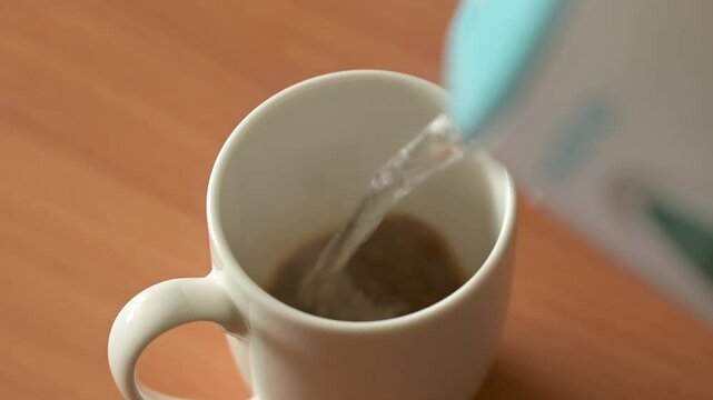 Making instant 3 in 1 coffee from the sachet in the morning. Video of parts of making coffee, pouring water, stirring beverage