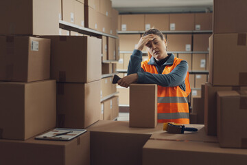 Exhausted sad warehouse worker having a break