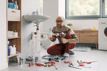 Inexpert man fixing his sink drain using adhesive tape