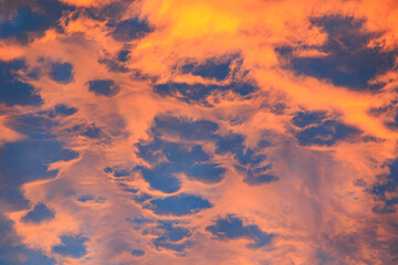 Orange glowing evening clouds in the sky above the Brunnenbach in the forest near Augsburg...