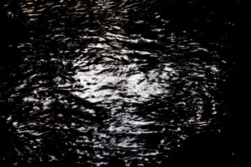  shimmering surface of the Brunnenbach stream in Augsburg Siebenbrunn