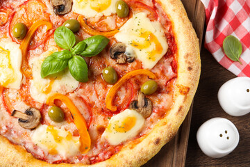 Delicious vegetarian pizza on wooden table, top view