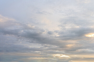 Dramatic cloudscape painted by a sunset, casting long shadows across the landscape