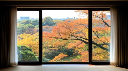 Fototapeta premium A large window reveals a breathtaking autumn landscape, featuring colorful trees and distant mountains bathed in warm, golden afternoon sunlight
