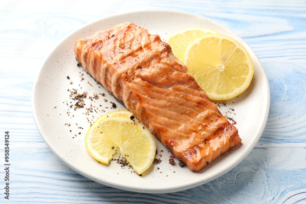 Sticker Delicious grilled salmon fillet served on light blue wooden table, closeup