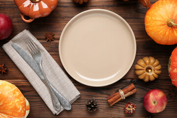 Stylish place setting and autumn decor on wooden table