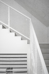 Fototapeta premium White staircase with netted railing, minimalist design featuring clean geometric lines, bright lighting, and abstract forms, blending modern architecture with functional simplicity.