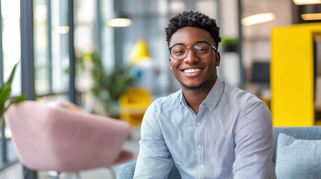 Confident young African American man smiling in a modern colorful office