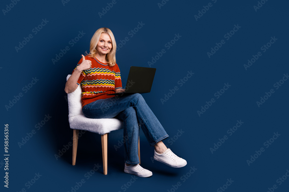 Sticker photo of charming lovely middle aged woman wear stylish clothes thumb up empty space isolated on dar